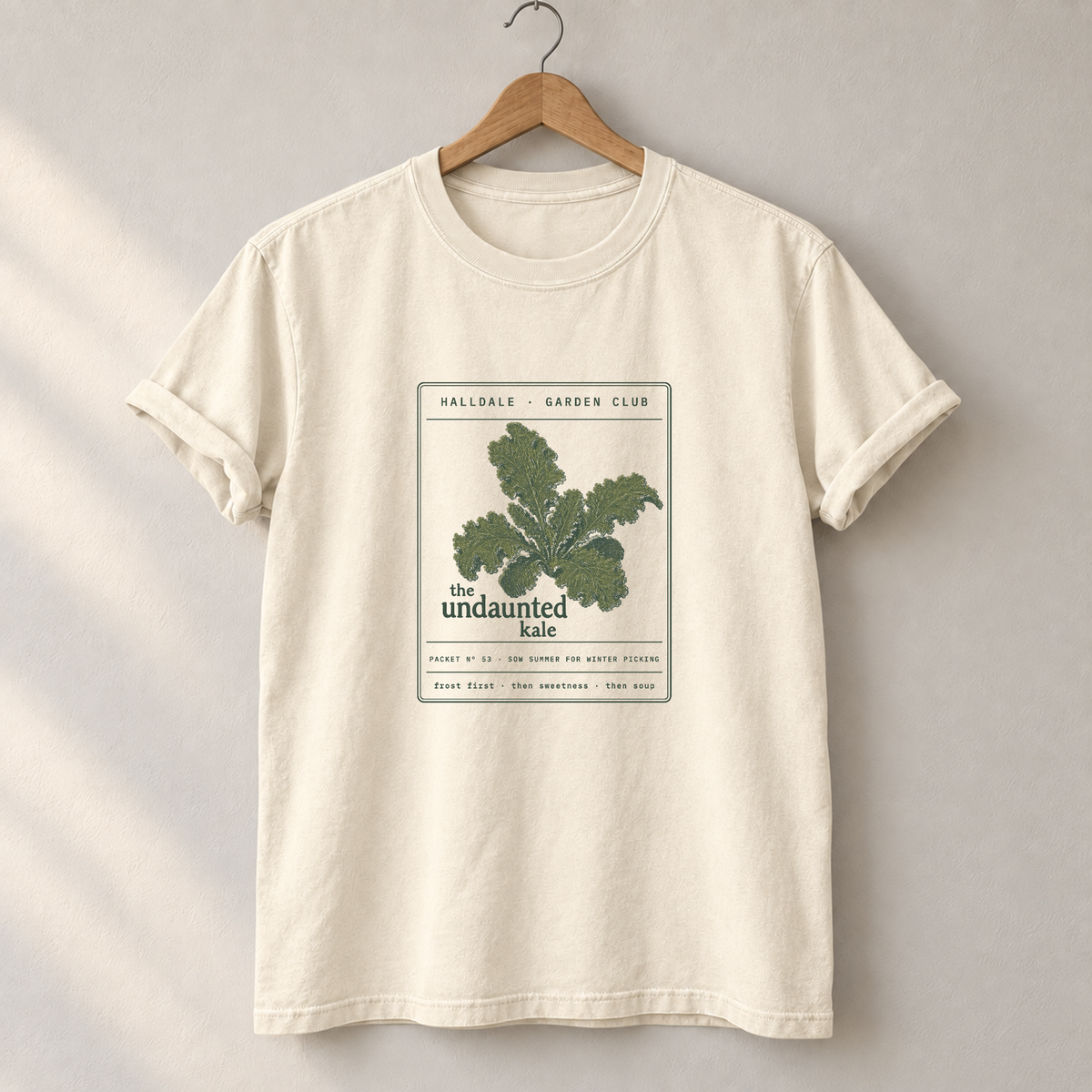 The Undaunted Kale tee in Ivory, on a hanger