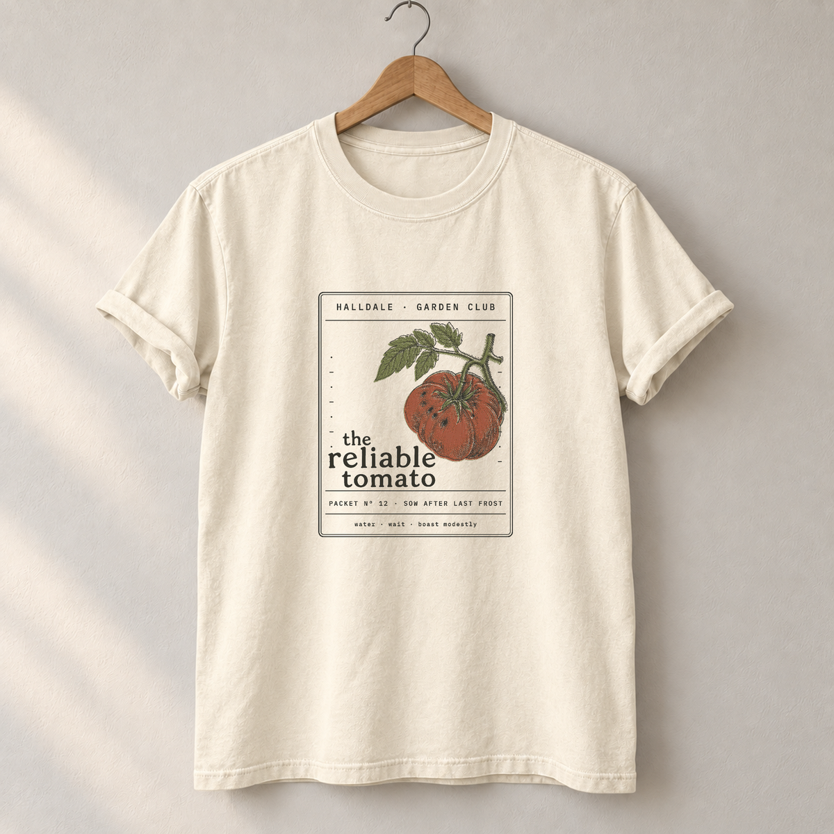 The Reliable Tomato tee in Ivory, on a hanger