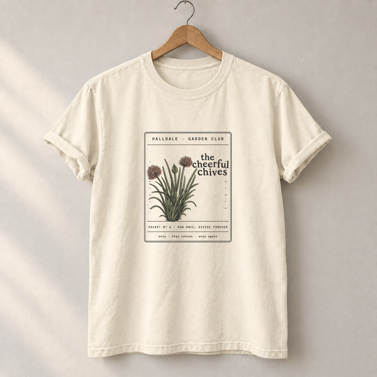 The Cheerful Chives tee in Ivory, on a hanger